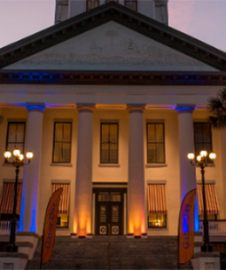 florida capitol illuminated with orange and blue lights