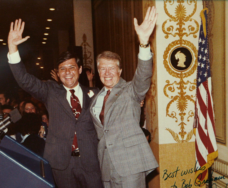 Governor Bob Graham and President Jimmy Carter wave to audience