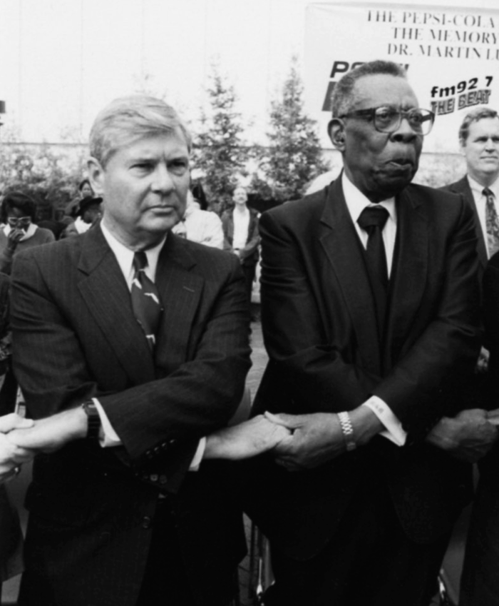 Bob Graham crossing arms and holding hands at Martin Luther King Junior march in Jacksonville, 1993