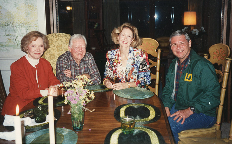 From left to right: Rosalynn Carter, Jimmy Carter, Adele Graham, and Bob Graham sit and smile around a table.