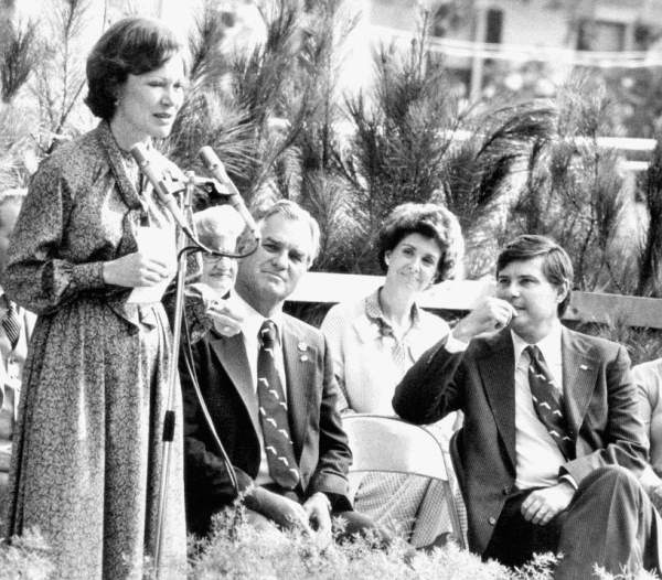 Rosalynn Carter at the podium of a political rally for Bob Graham during his first gubernatorial campaign. Next to her sits Wayne Mixson, Adele Graham, and Bob Graham.