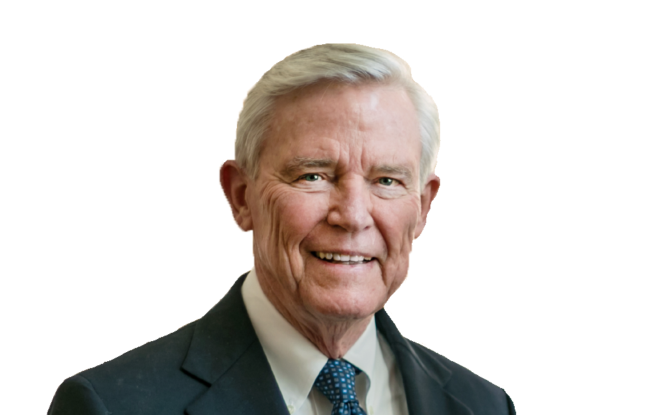 A person in a dark suit and patterned tie looks directly at the viewer